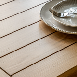 Close-up of Eton Table plank-style oak tabletop with ceramic plate and fork
