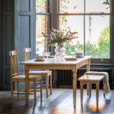 Bright dining space with Eton Oak Table, chairs, and bench near window