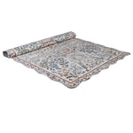 Evangeline vintage inspired scallop edge rug partially rolled showing floral border and scalloped edge