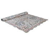 Evangeline vintage inspired scallop edge rug partially rolled showing floral border and scalloped edge