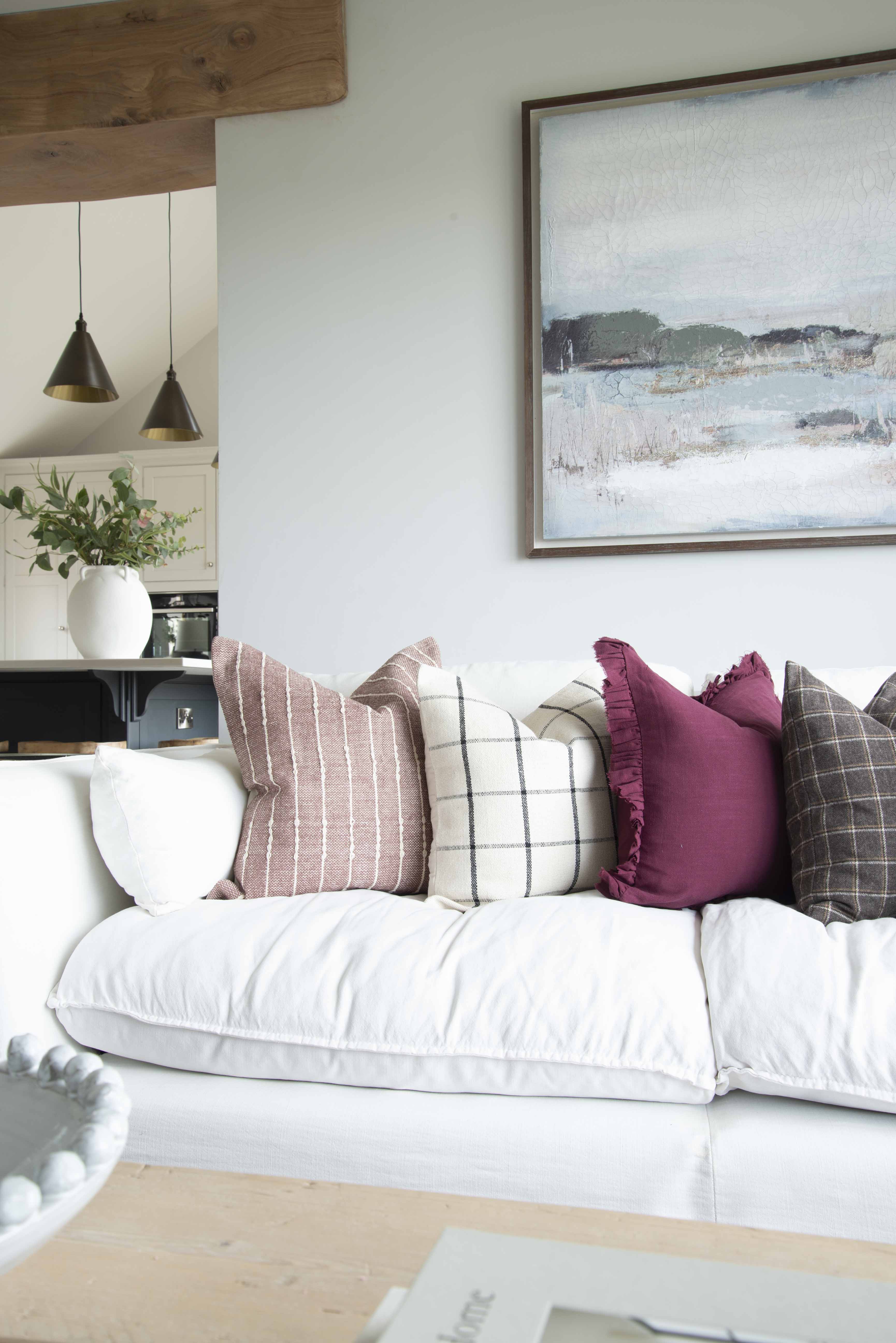 A stunning plum cotton cushion with a beautiful check Detail in cream.