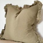 A beautiful linen cushion in a soft olive colour featuring ruffled edges.