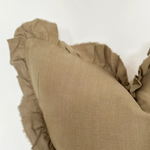 A beautiful linen cushion in a soft olive colour featuring ruffled edges.