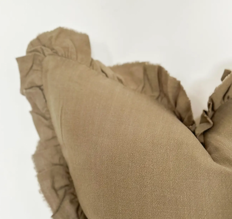A beautiful linen cushion in a soft olive colour featuring ruffled edges.