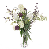 Faux tulip and artichoke floral arrangement in a clear glass vase with viburnum thistles and eucalyptus foliage