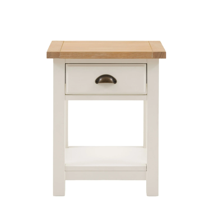 Florence bedside table in oak and white with drawer and open shelf beside a bed