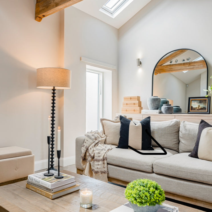 A stunning floor lamp in black featuring a beautiful turned base complete with off white linen shade.