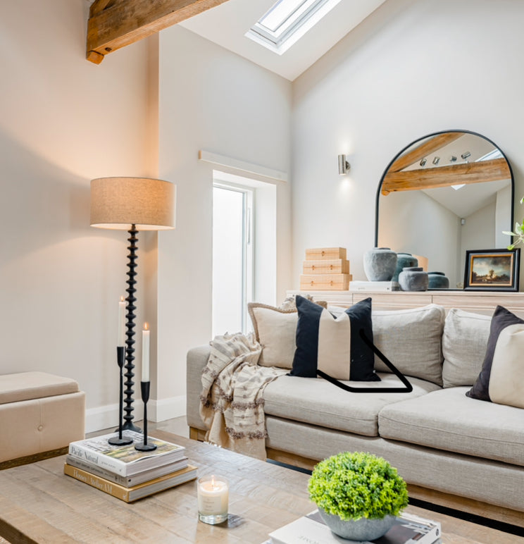 A stunning floor lamp in black featuring a beautiful turned base complete with off white linen shade.