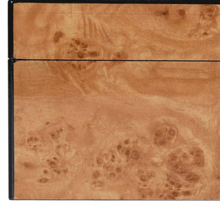 Close-up detail of the Goring's faux burl wood finish, showing the swirling figured grain and warm caramel tones of the lacquered surface