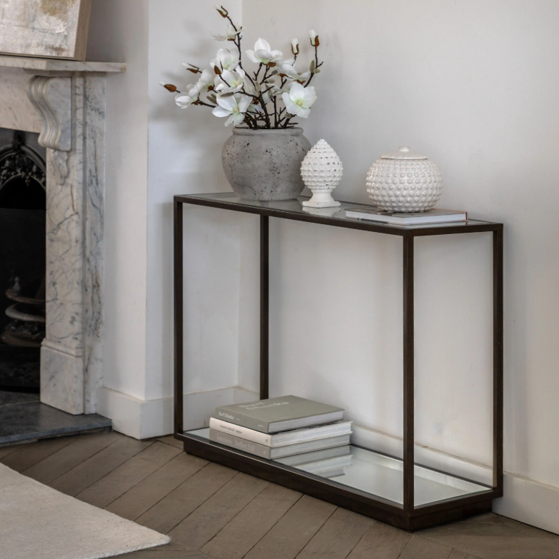 Geneva Glass Console Table with clear glass shelves and modern metal frame in hallway