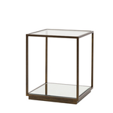 Glass side table with bronze metal frame on a white background