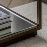 Geneva Glass Side Table with clear glass shelves and modern metal frame beside sofa