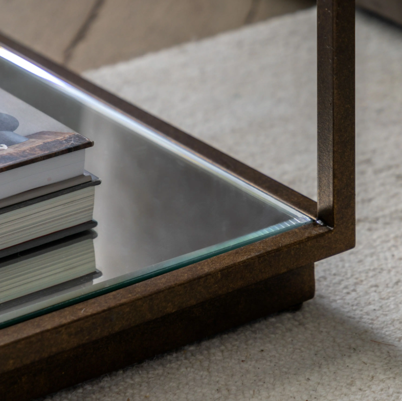 Geneva Glass Side Table with clear glass shelves and modern metal frame beside sofa