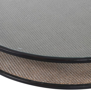 Close up picture of the glass top and rattan shelf