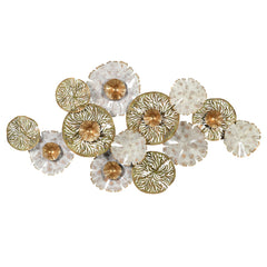 A decorative metal artwork featuring a cluster of golden floral designs with white accents.