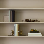 Pair of antique gold ginkgo bookends on shelf