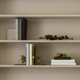 Pair of antique gold ginkgo bookends on shelf