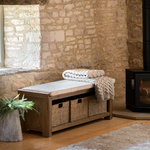 Hardwick Hall Bench made from oak and oak veneer with a cushioned seat and three seagrass storage baskets
