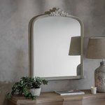Arched wall mirror with decorative crest and beaded frame in a vintage gray finish