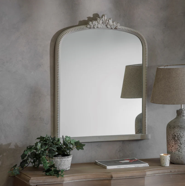 Arched wall mirror with decorative crest and beaded frame in a vintage gray finish