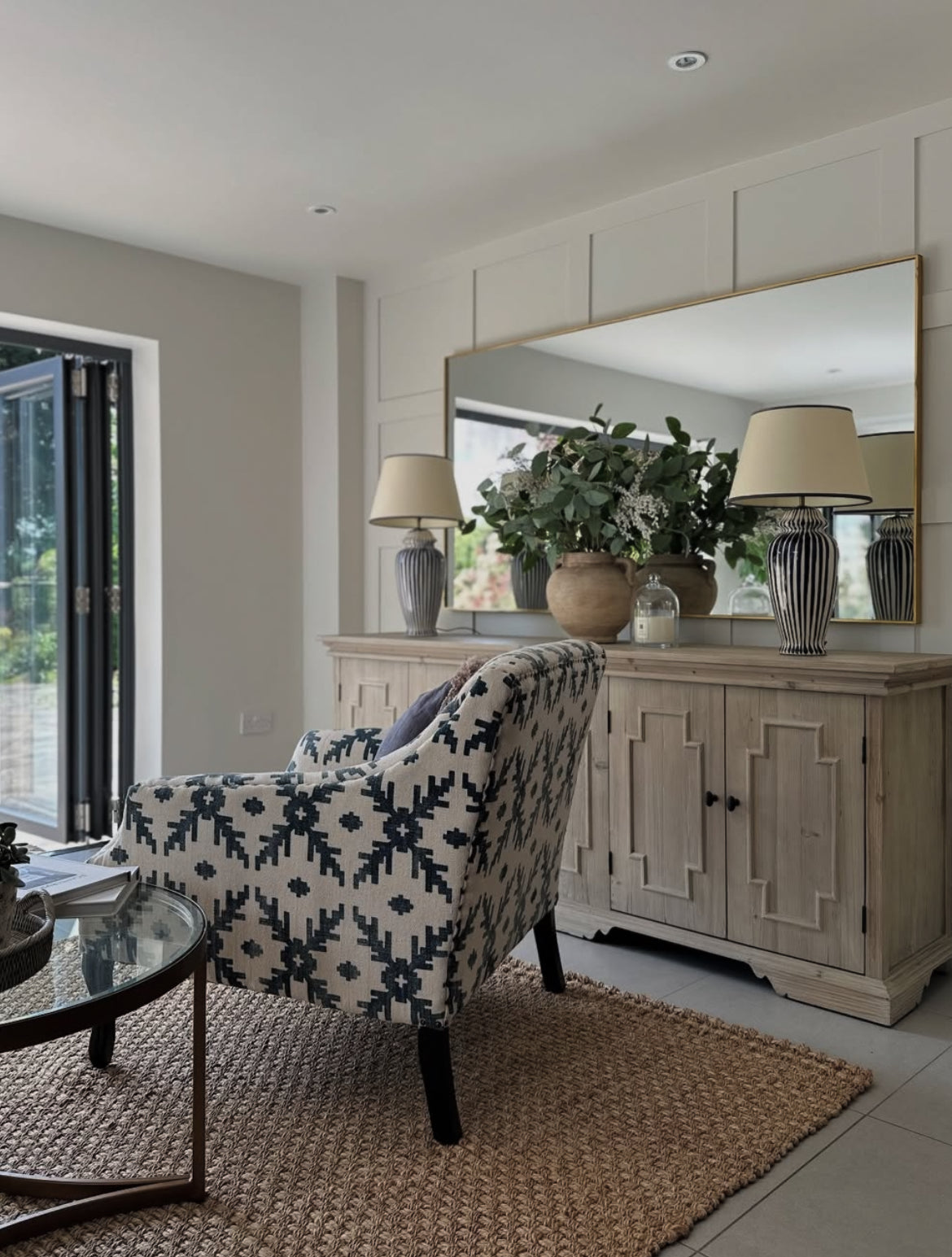Harrogate sideboard styled with mirror and decor in living room