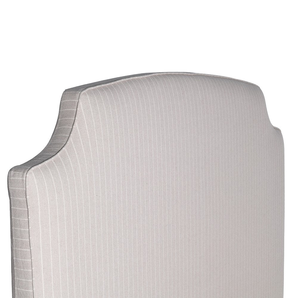 Henrietta upholstered bed with curved padded headboard and neutral fabric finish