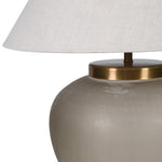 Elegant Hera glass table lamp with brass detailing and linen shade