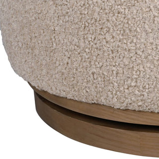 Close-up of the Holkham chair's curved wood hoop frame and integrated 360-degree swivel base