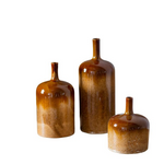 Three brown ceramic bottles of varying sizes on a white background