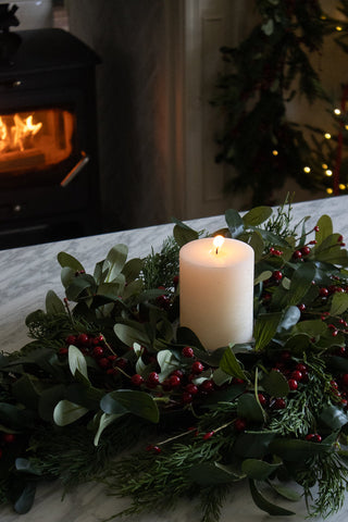 Close detail of olive leaves, eucalyptus and red berries on the small 30cm wreath