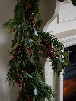 Faux cypress and olive leaf garland with red berries