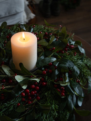Small 30cm olive leaf and red berry wreath with candlelight by the fireplace