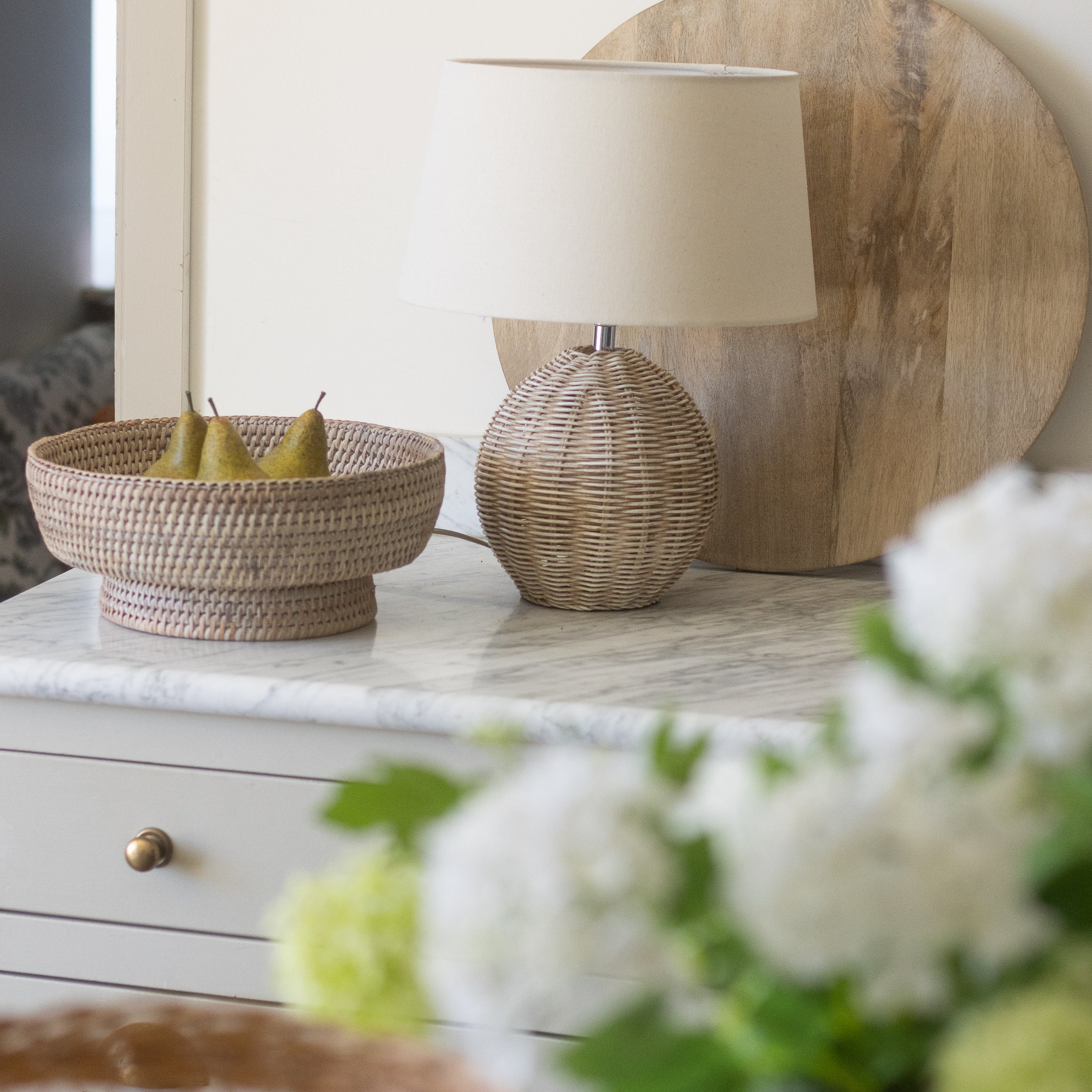 woven wicker fruit bowl on marble counter
