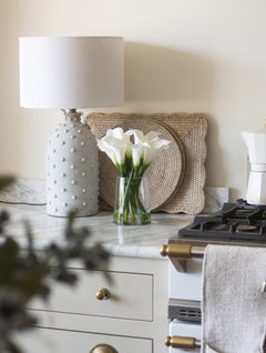 white cala lilies on a marble kitchen counter