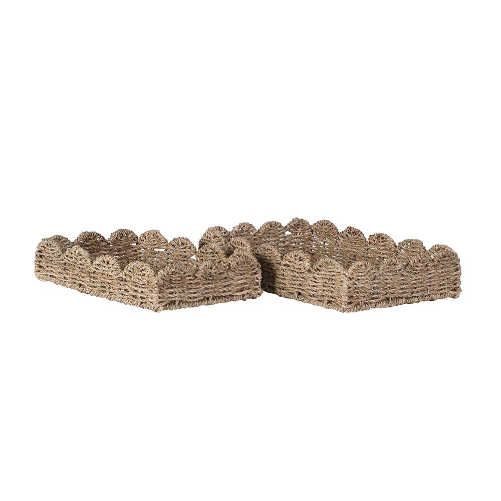 Two woven seagrass planters on a white background