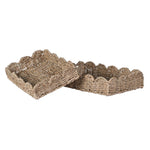 Two woven baskets with scalloped edges on a white background