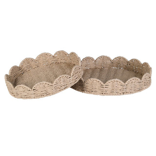 Two round woven trays with scalloped edges in a natural beige material, shown overlapping on a plain white background.