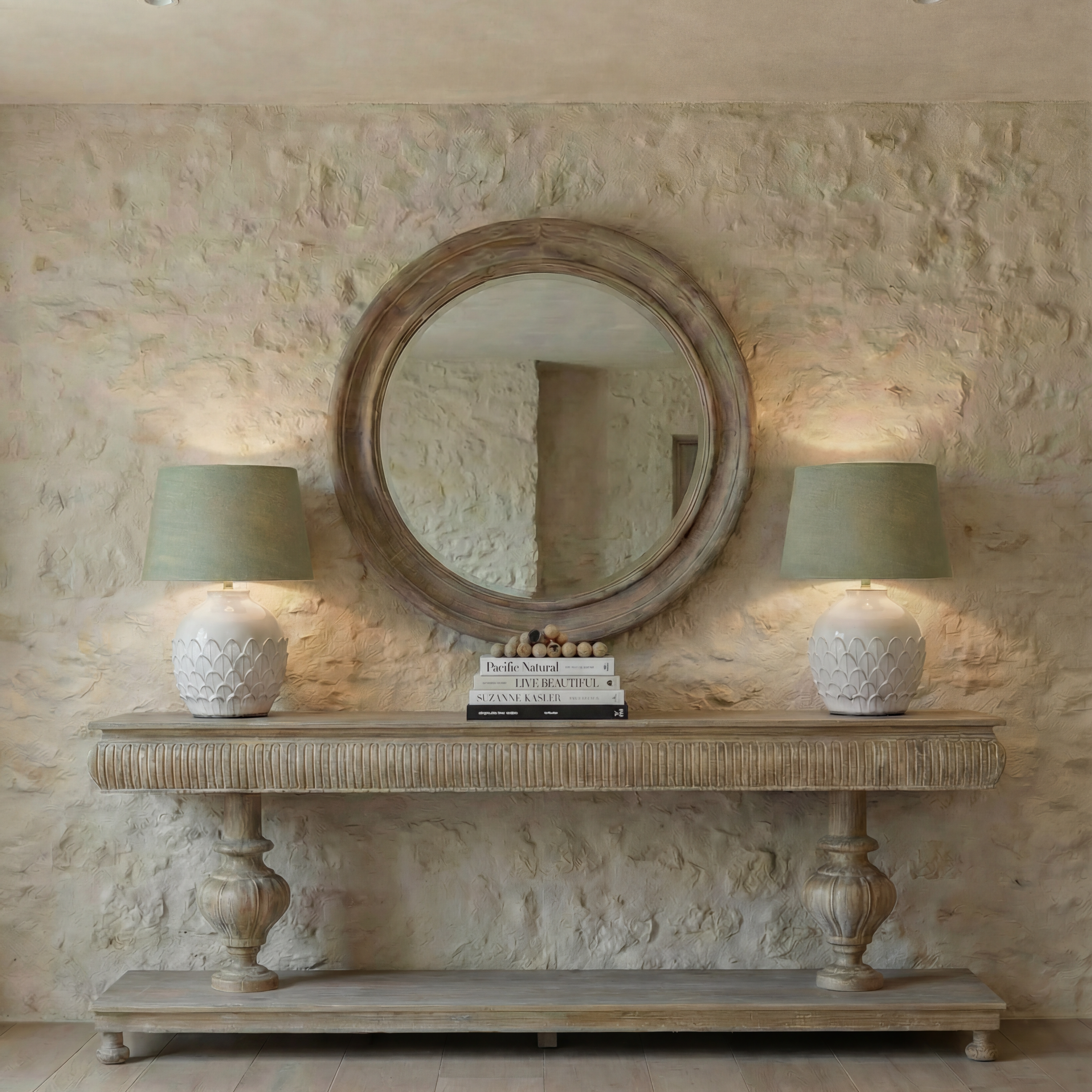 Wooden console table with decorative pedestal base against a plain wall