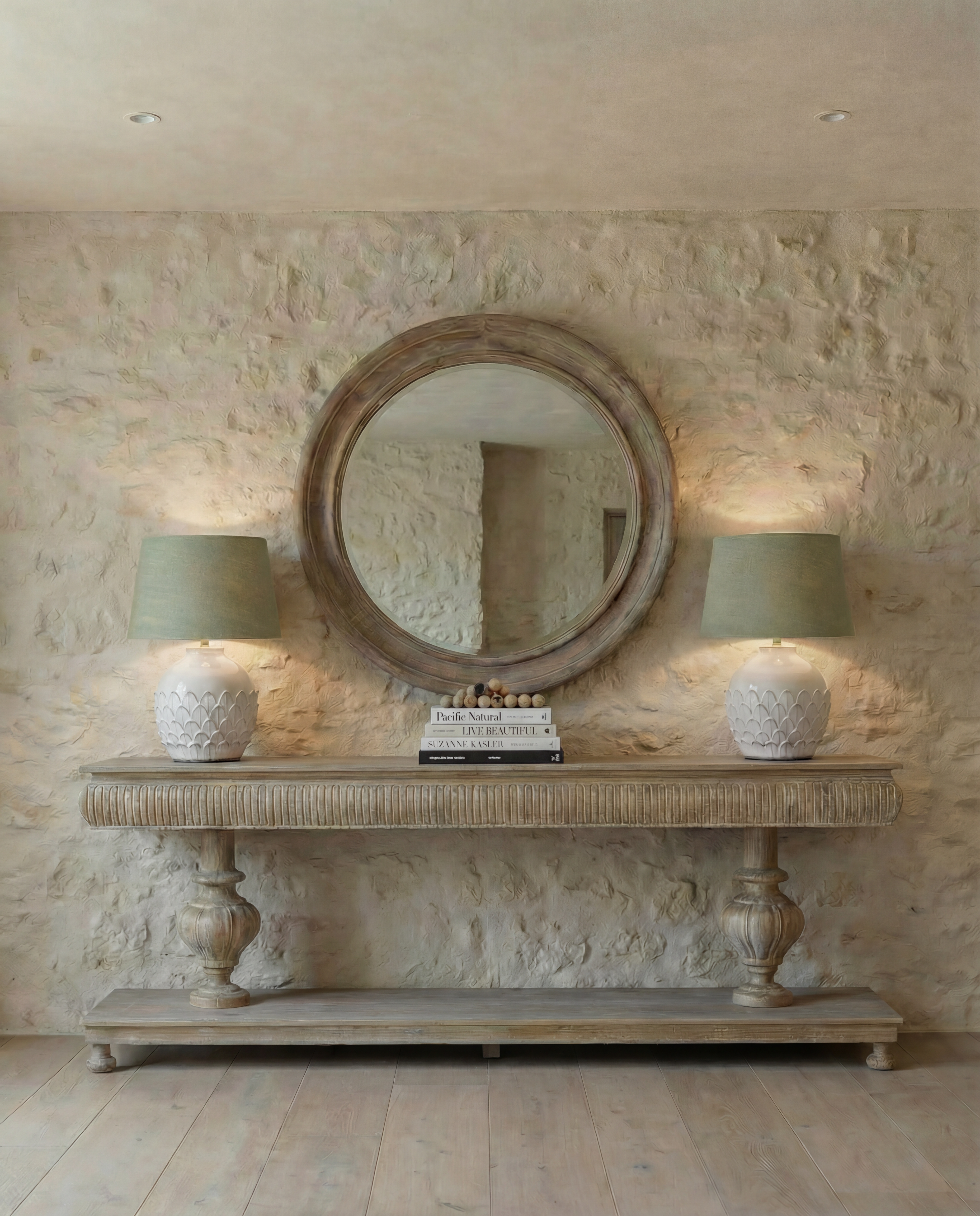 Wooden console table with decorative pedestal base against a plain wall