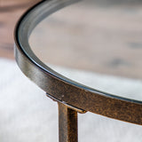 Jenner bronze glass coffee table with two tier oval glass shelves in a modern living room setting