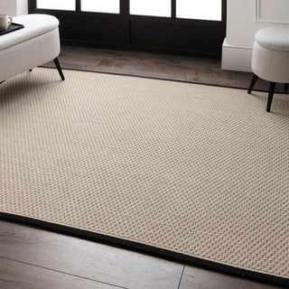 Korra Double Loop wool and jute rug in charcoal and cream styled in a living room