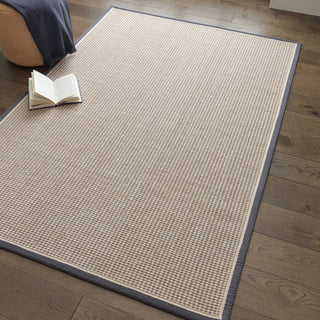 Korra Loop wool and jute rug in slate and cream styled in a living room