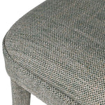 Indulge in the luxurious comfort of the Kristin Open Back Dining Chair, crafted with a woven textured fabric in a soft cream hue with subtle hints of moss green. Elevate your dining experience with this sophisticated and exclusive piece.