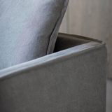 Stone washed linen sofa with deep cushions and modern slipcover style in a contemporary living room