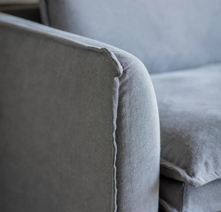 Stone washed linen sofa with deep cushions and modern slipcover style in a contemporary living room