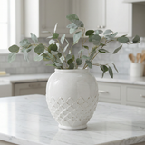 White lotus ceramic vase with woven pattern on a white background