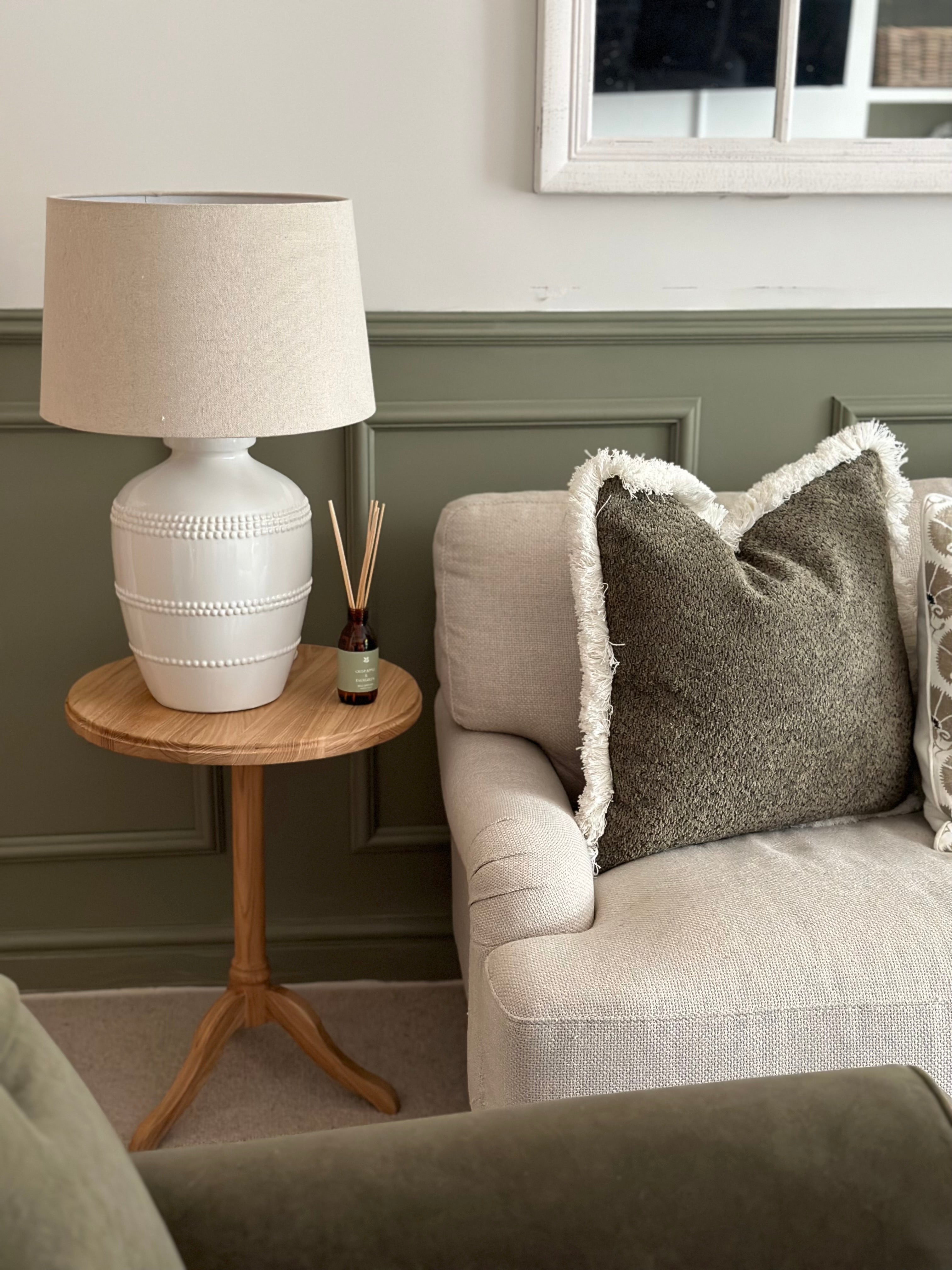 Lucia White Ceramic Table Lamp with beaded detailing and linen shade styled in living room