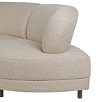 Detailed view of the boucle texture and rounded arm of the Lumin Curved Sofa
