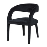 A black velvet open back chair with a upholstered seat and backrest, standing on a angled front leg design.