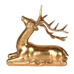Majestic Golden Starlight Reindeer figurine laying down with detailed antlers in gold finish